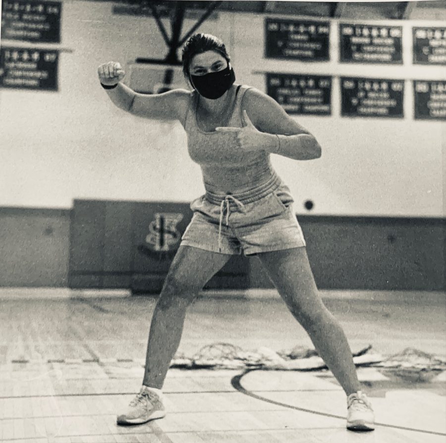 Junior Alex Harner wears her cross-country shorts in the Friends School gym.