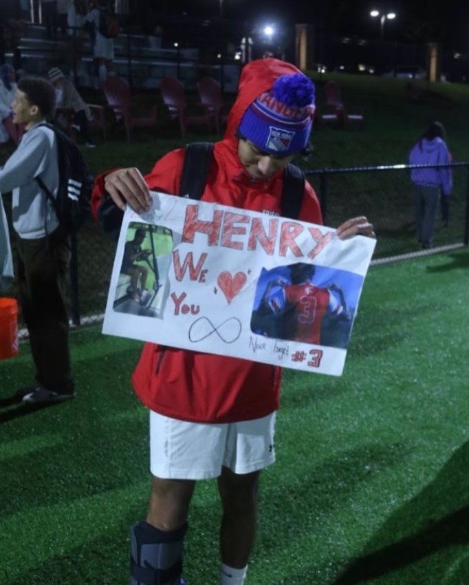 Center midfielder Henry Sellinger holds a card from his teammates.