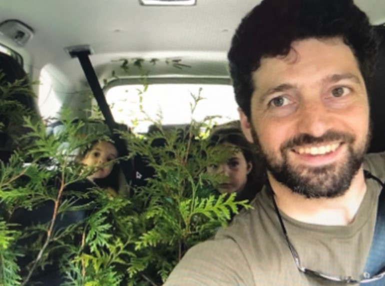 English teacher Joshua Ratner buys plants with daughters Iris and Eleanor.