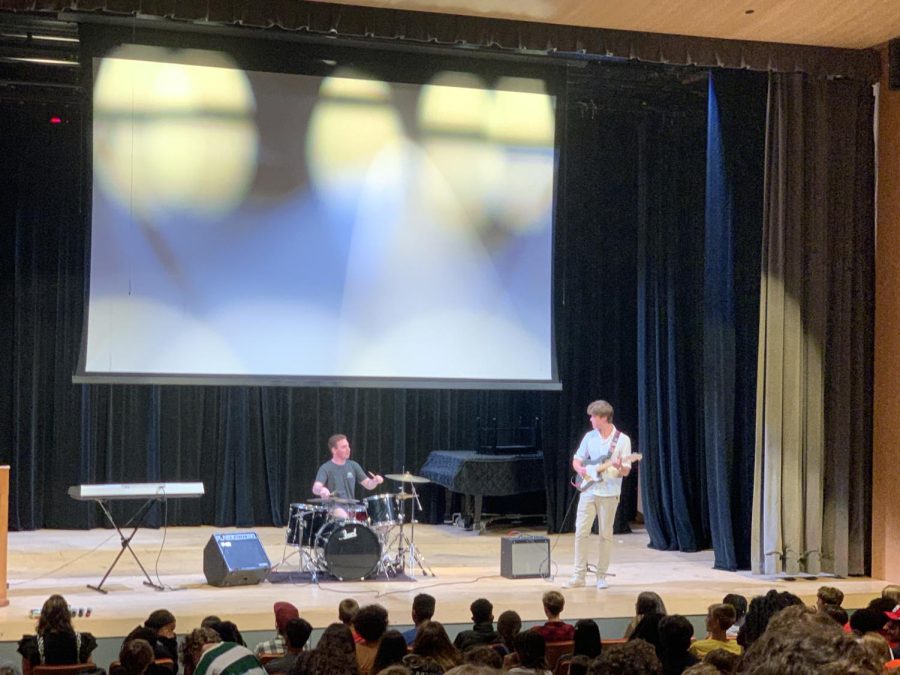 Juniors Harrison Fribush on drums, and Dominic Saunders on guitar, play at the 22-23 school years first Upper School Collection.