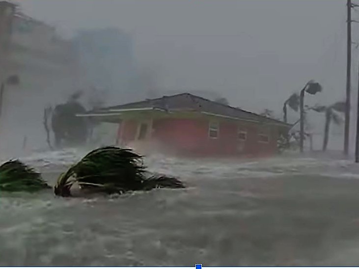 In this screen-grab from a video by storm chaser Max Olson, a Fort Meyers, FL, house is in the process of being swept away by a 15-foot wall of water.