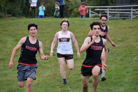 Cross country runners Sam Wu, Vincent Walk, and Jonah Rubenstein are pursued by a Park runner during the Rivalry meet.