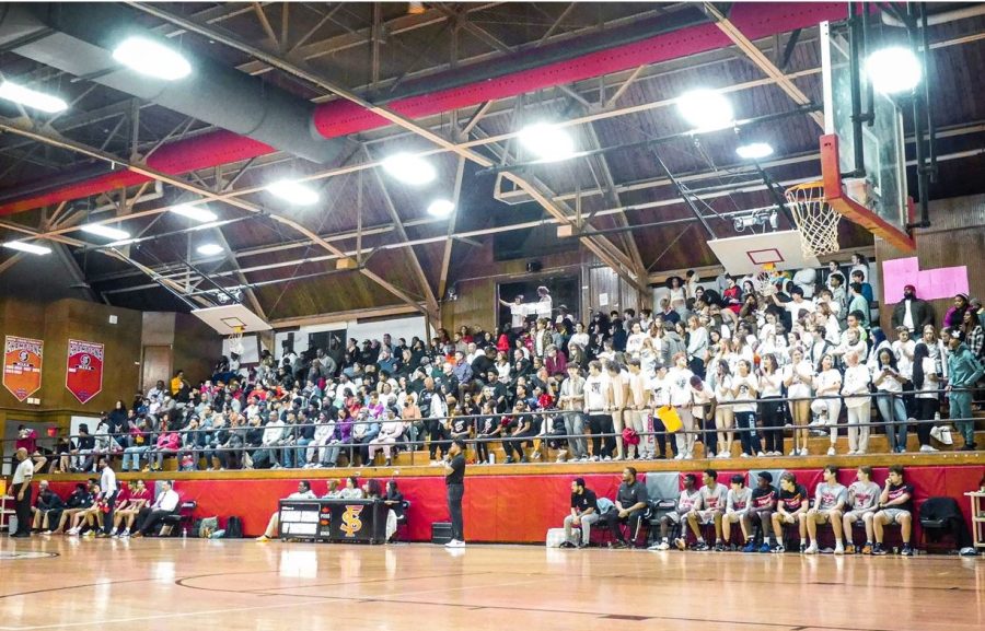 The+stands+were+packed+with+fans+wearing+white+for+boys+Varsity+Basketballs+tense+Senior+Night+game.
