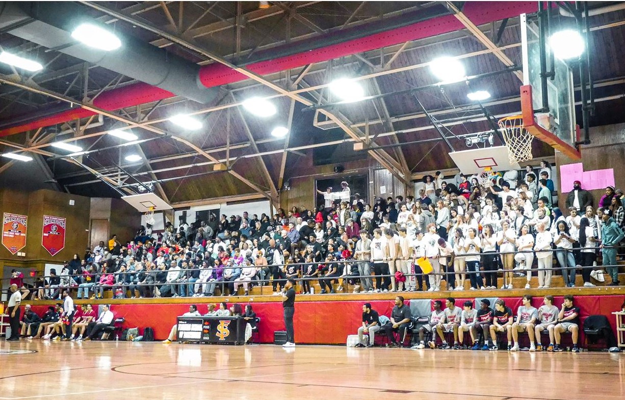 The stands were packed with fans wearing white for boys' Varsity Basketball's tense Senior Night game.