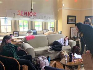 Seniors enjoy the club decor in the converted teachers lounge as part of their senior prank.