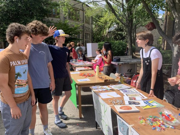 Senior Maeve Reichert, head of the literary magazine Mock Turtle, talks to potential 9th grade recruits during the 2023 clubs fair.