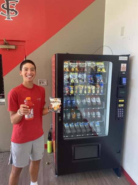 Junior Mason Cost prepares to sample items from the new Friends vending machine.