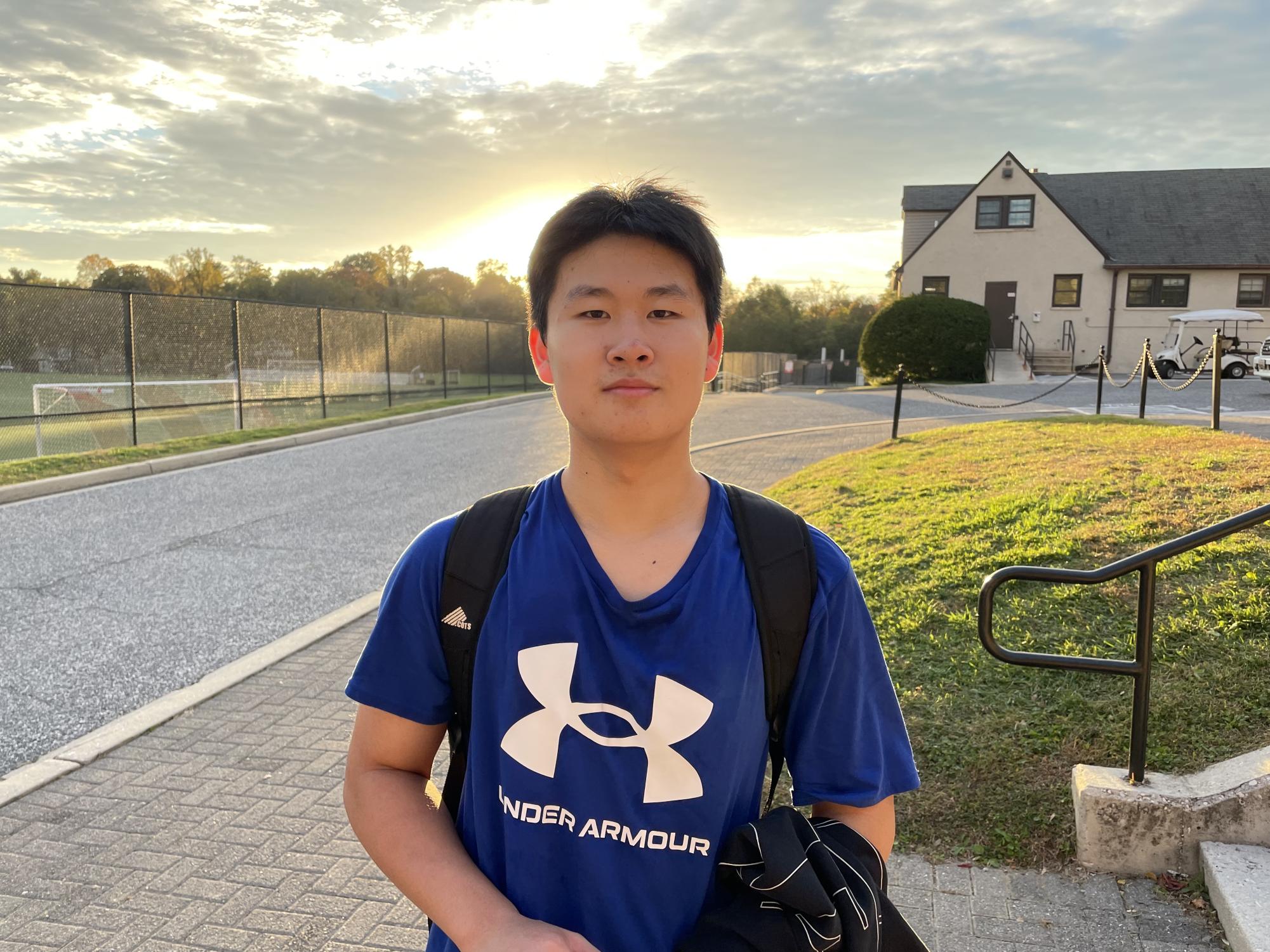 Junior Yipeng Lu stands on the campus of Friends School of Baltimore. The Chinese student wanted to come to Friends so badly, he went to college first to prove himself.