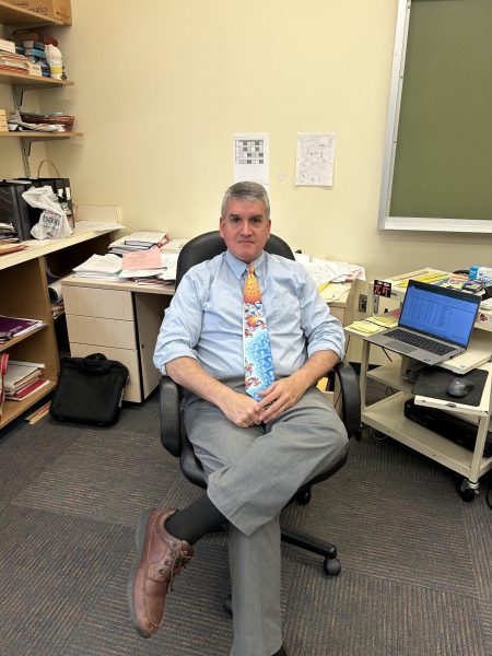 Beloved Friends math department chair Carl Schlenger sits in his classroom, three decades after he made the decision to leave the law for teaching.