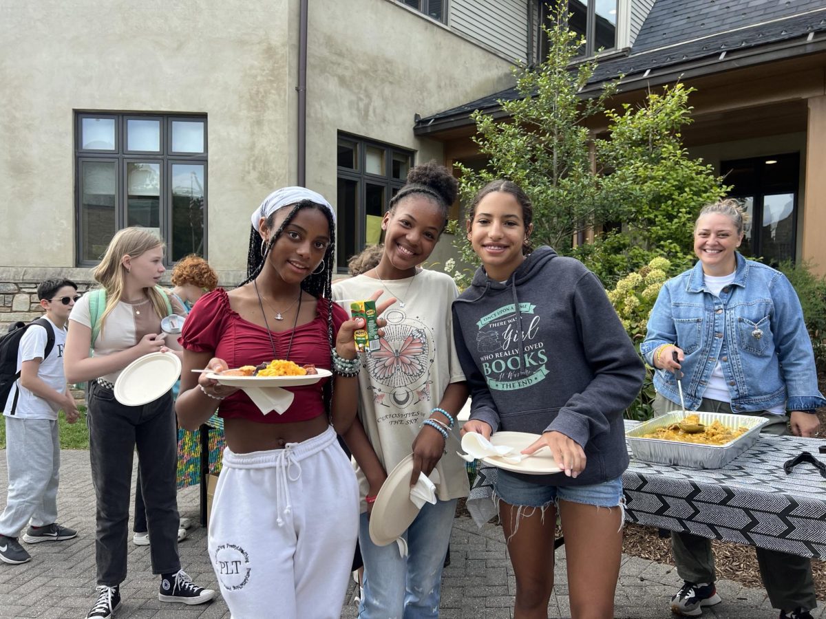 Eighth graders Nadia Lewis, Zahara Al-Uqdah, and El Cheshire prepare to feast during African Diaspora Day in the Middle School.