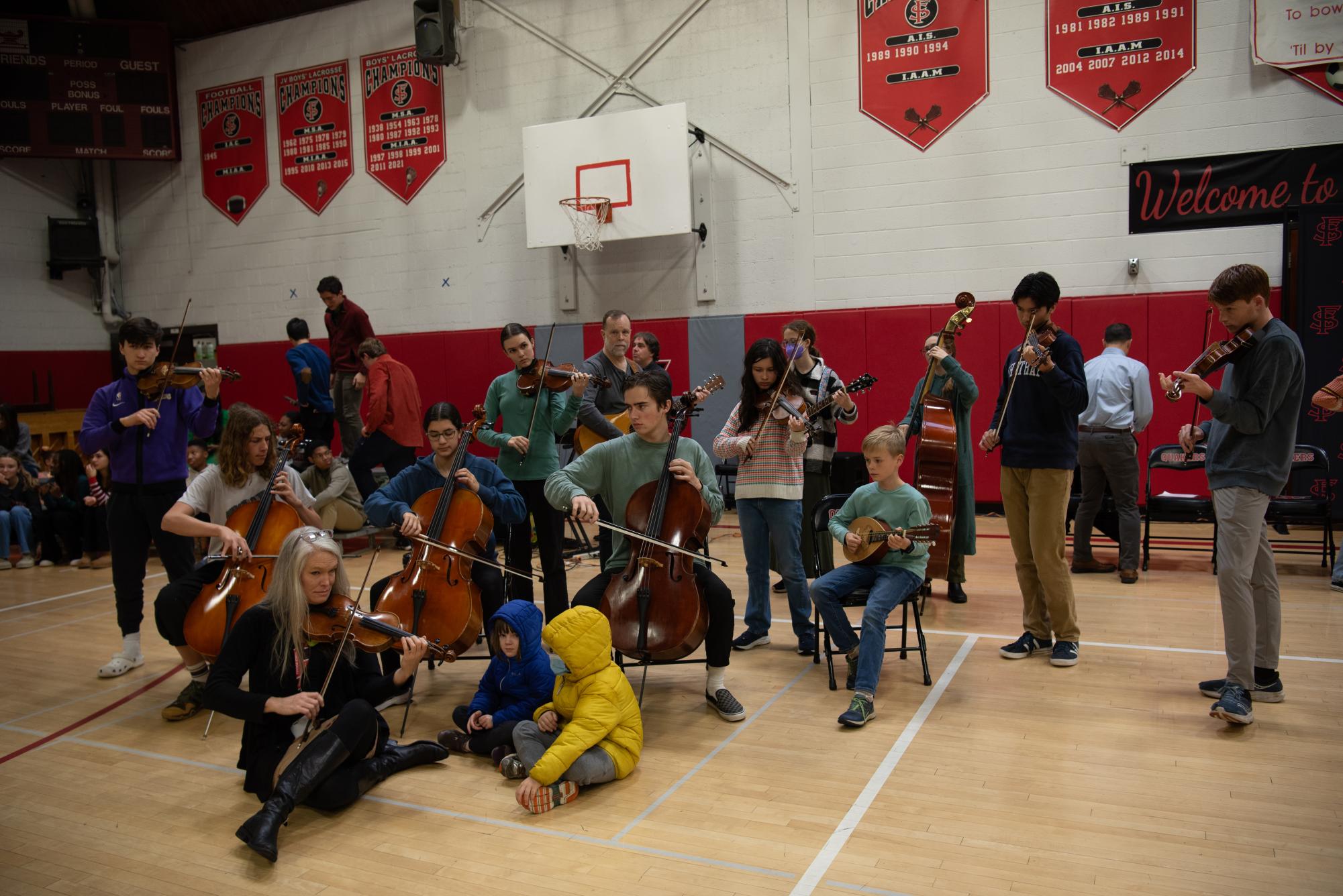 Students and teachers in Friends Schools Fiddle Club performed as community members of all ages filled the Old Gym for the annual Thanksgiving Convocation.