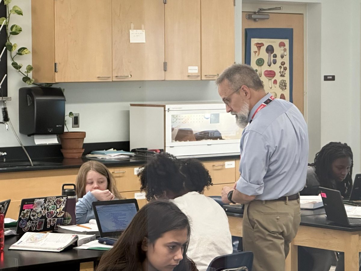 Veteran Life Science teacher Andrew Spawn confers with a sixth grade student.