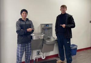 Our reviewers pose with one of the Friends campus top-scoring water fountains.