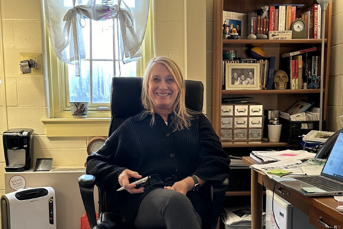 Ninth grade dean Christine Saudek sits in her office. Last year, the beloved English teacher celebrated 14 years at Friends.