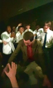 Teacher Josh Carlin is surrounded by a crowd of students as he takes the dance floor at the semi-formal.