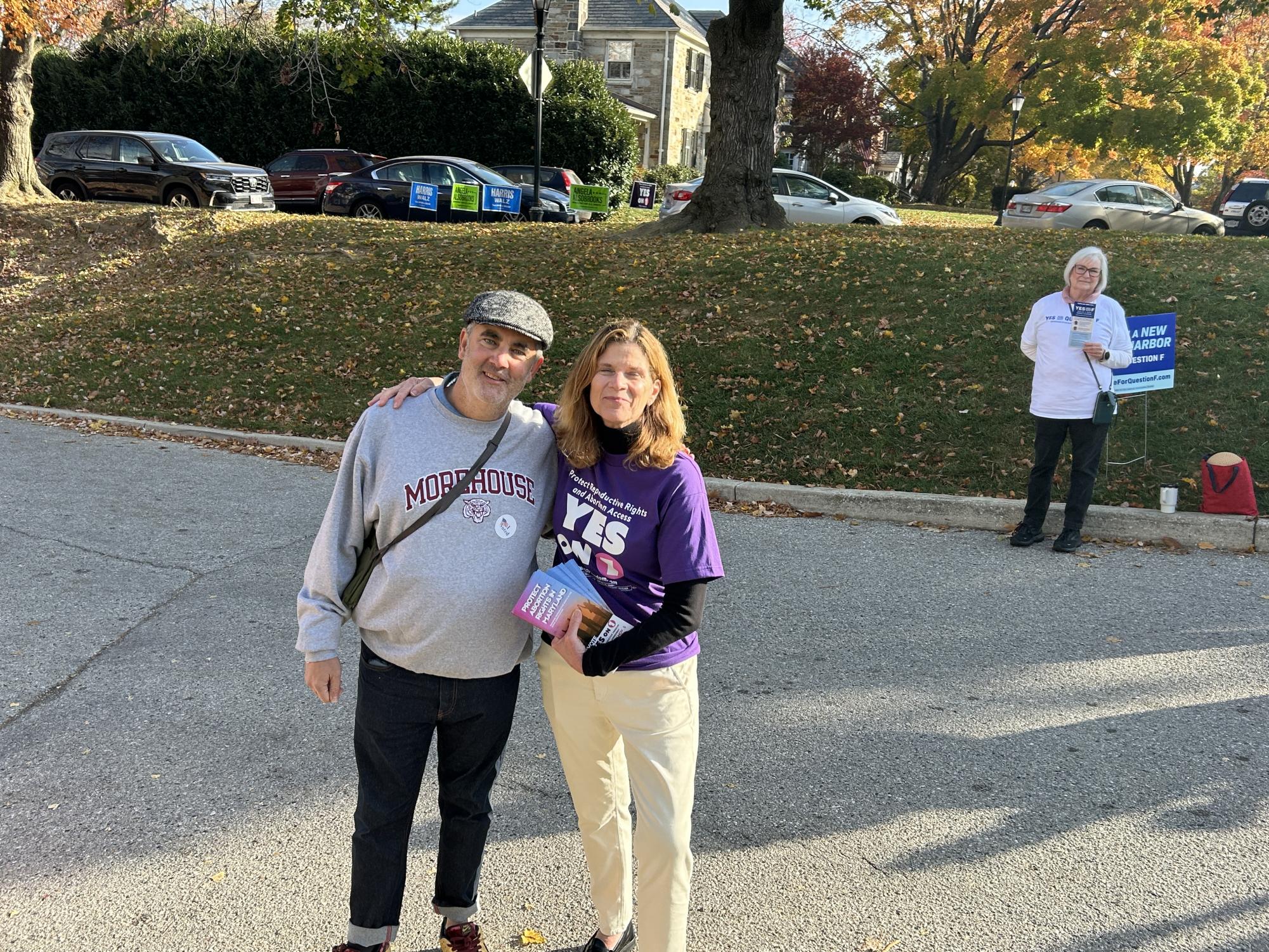 Activist Katie O'Malley poses with friend Patrick Daniels at the Grace Church polling place.