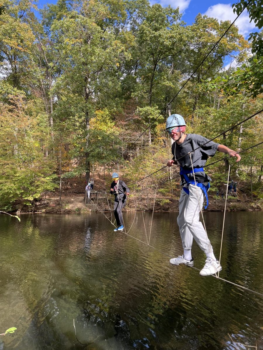 Students attempt to cross the rope bridge blindfolded.