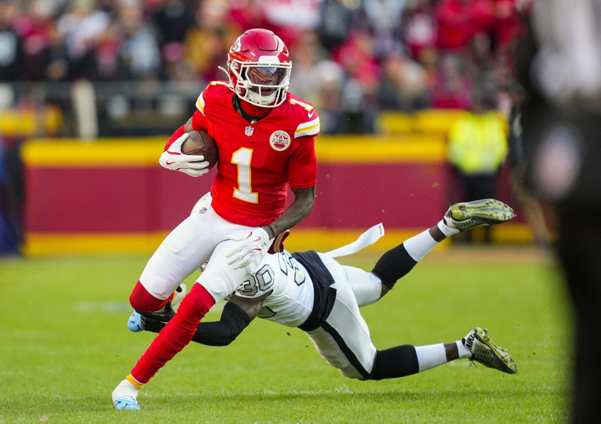 Kansas City Chiefs wide receiver Xavier Worthy runs with the ball against Las Vegas Raiders cornerback Darnay Holmes during a game last November. This season, the Chiefs are counting on him.