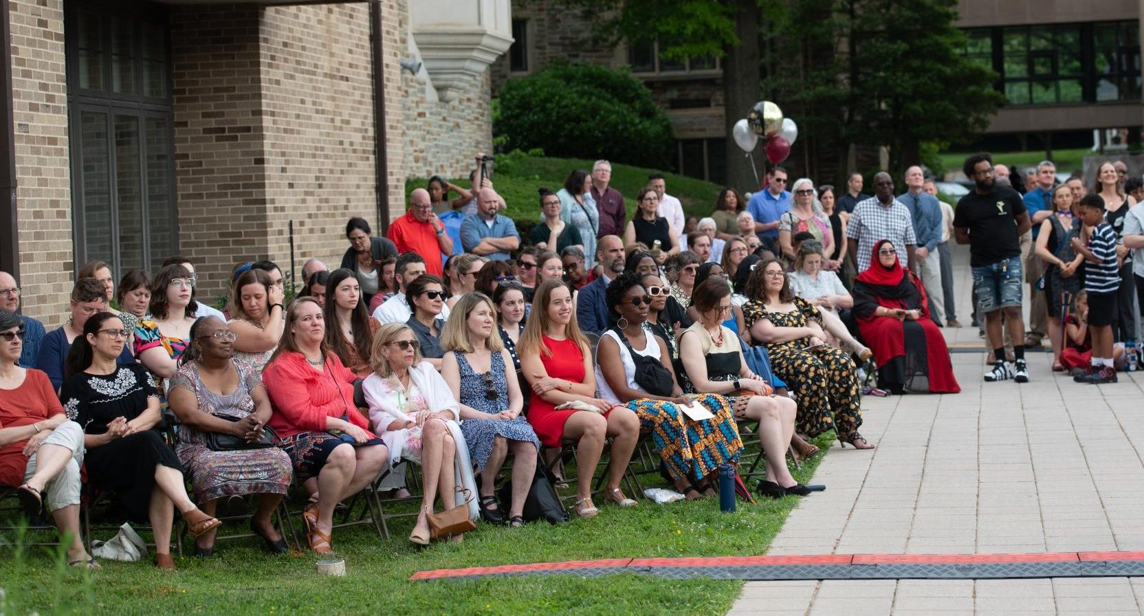 Koniezhny (front row, blue dress) sits with fellow teachers at graduation in June 2024, two months after learning of her diagnosis.
