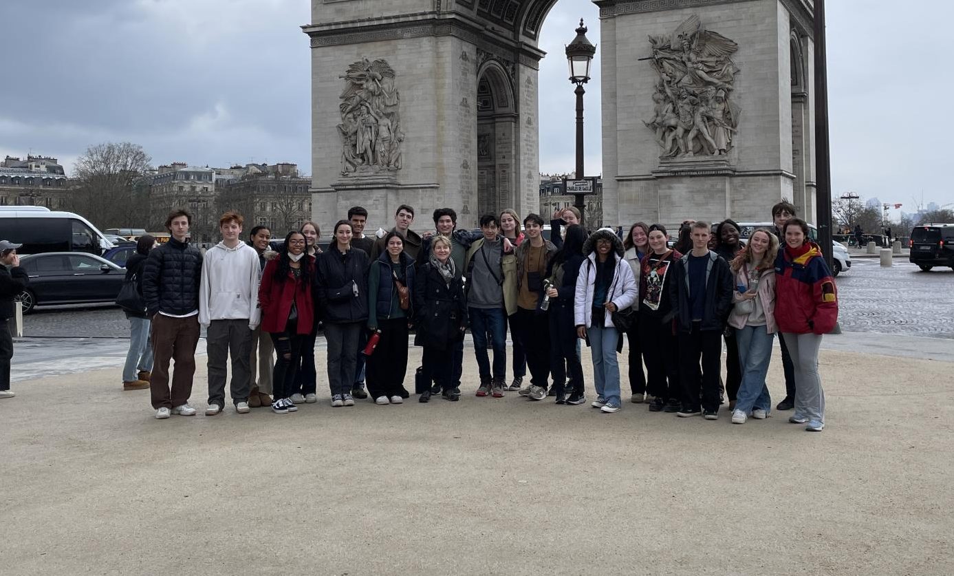 In March 2024, Koniezhny (center, with students at the Arc de Triomphe) found that, unlike on previous Spring break language trips, she was having trouble keeping up with them.