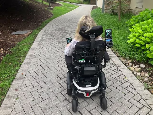 On campus, several outdoor paths - including this one from the Dining Hall to the quad - are navigable by wheelchair. But the hill down from the Upper School lot onto campus is steep, uneven, and icy in winter months - treacherous for users of mobility devices.