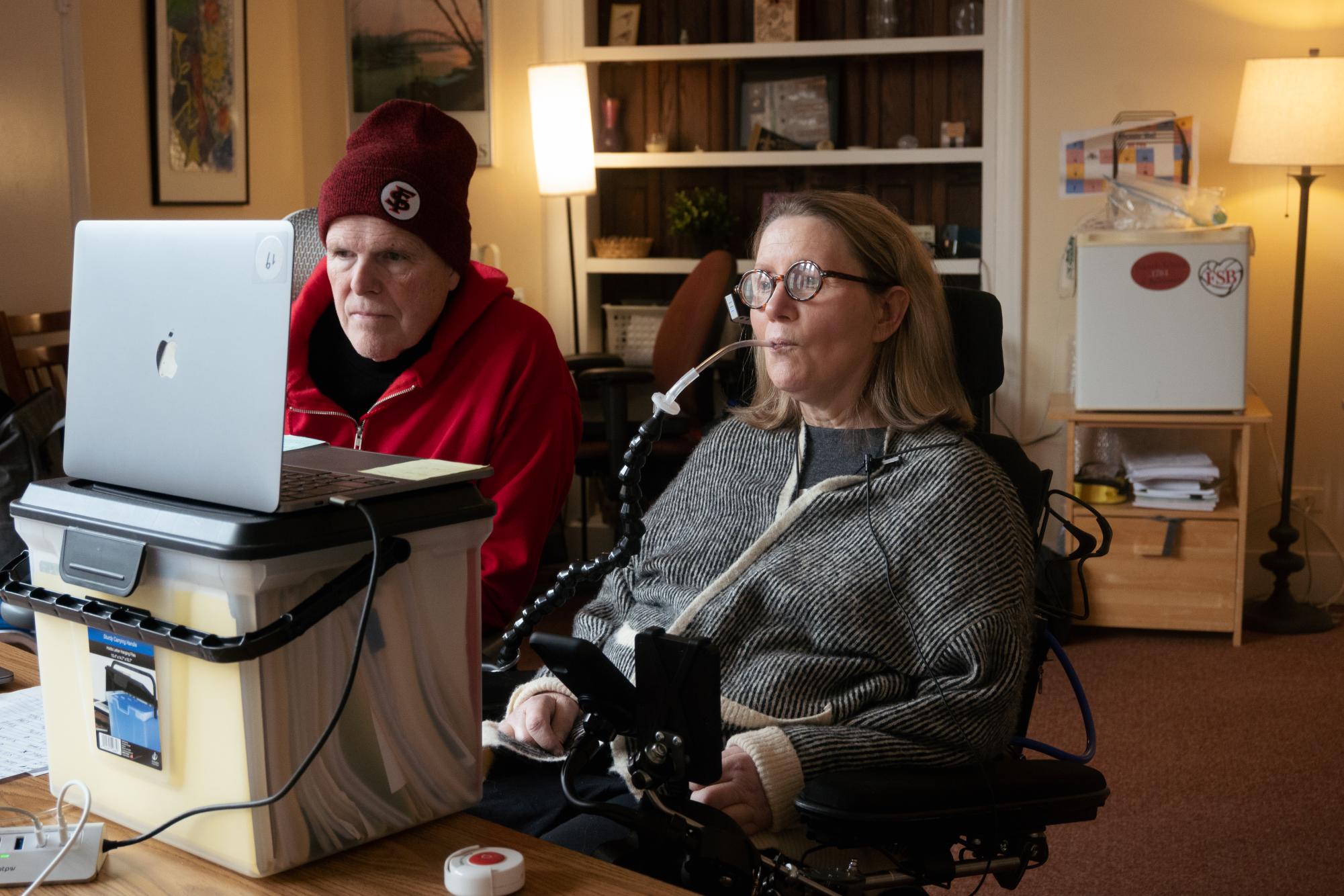 Koniezhny and partner Danny Mydlack in her room in December. As her disease progressed, the pair experimented with all sorts of assistive technology to help her continue working at Friends as long as possible. At this stage, although unable to move her hands, she was still showing up for Zoom calls and continuing the regular business of Assistant Principal life.