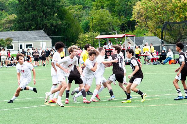 Friends School varsity soccer players try to break free from Park School defenders to make a play on rivalry day.